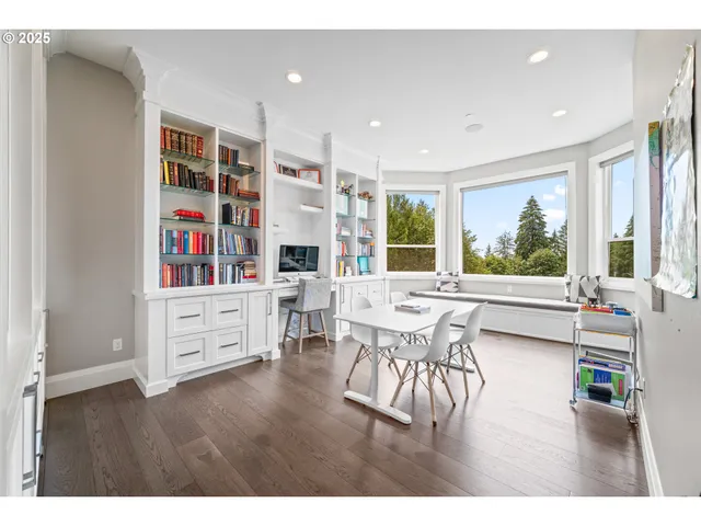 a dining room with furniture and wooden floor