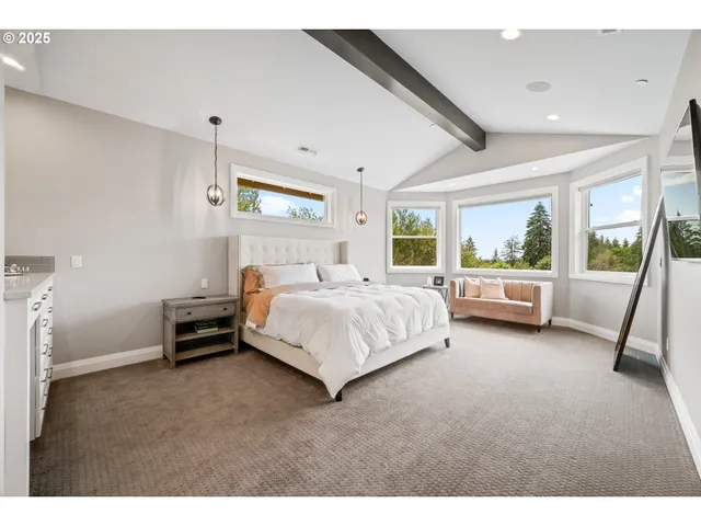a bedroom with a bed and a view of living room