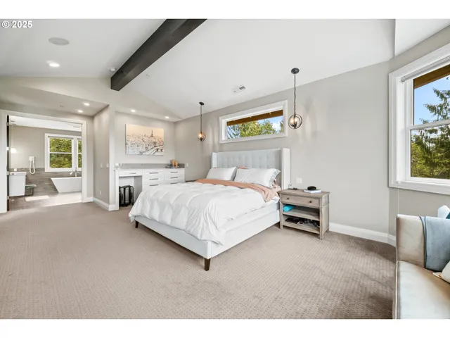 a bedroom with a bed wooden floor and window