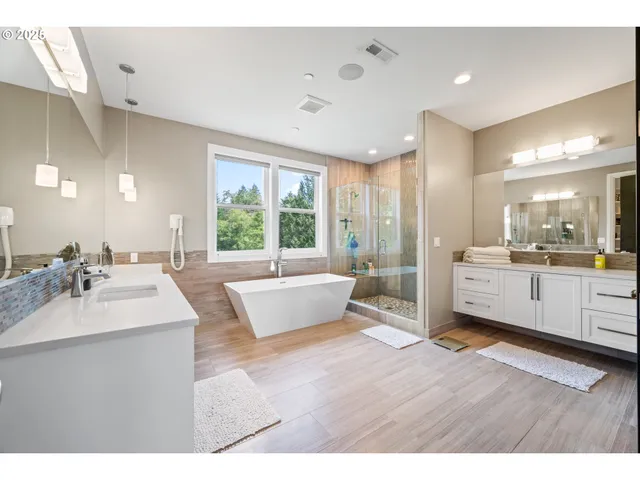a large bathroom with a large tub and sink