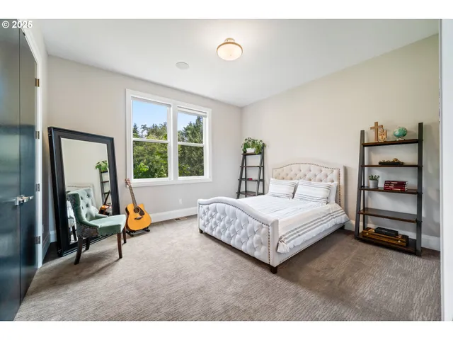 a bedroom with a bed a large window and gym equipment
