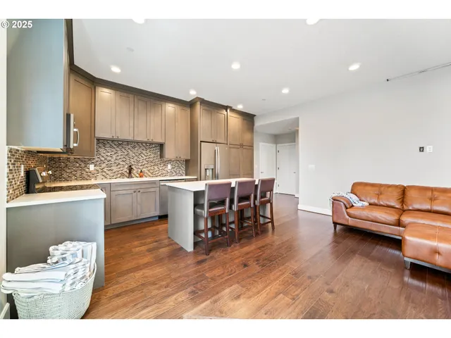 a open kitchen with stainless steel appliances kitchen island granite countertop a sink and cabinets