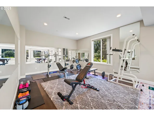 a living room with furniture a wooden floor and next to a window
