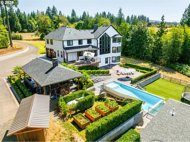 a view of a house with swimming pool and sitting area