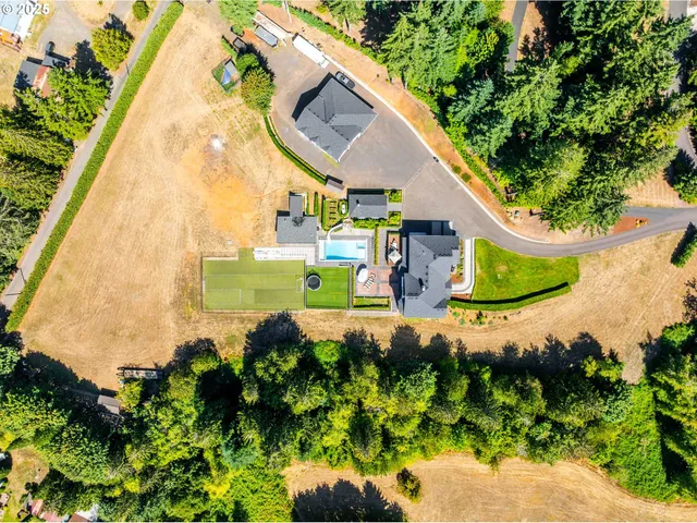 an aerial view of a house with a yard and outdoor seating
