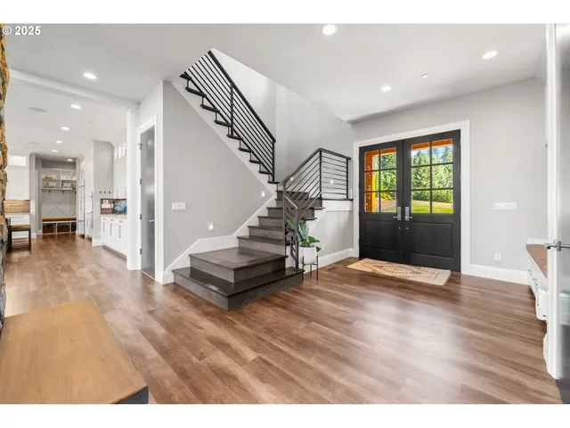 a view of an entryway with wooden floor