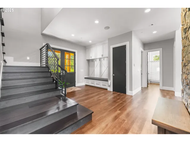a view of entryway and hall with wooden floor