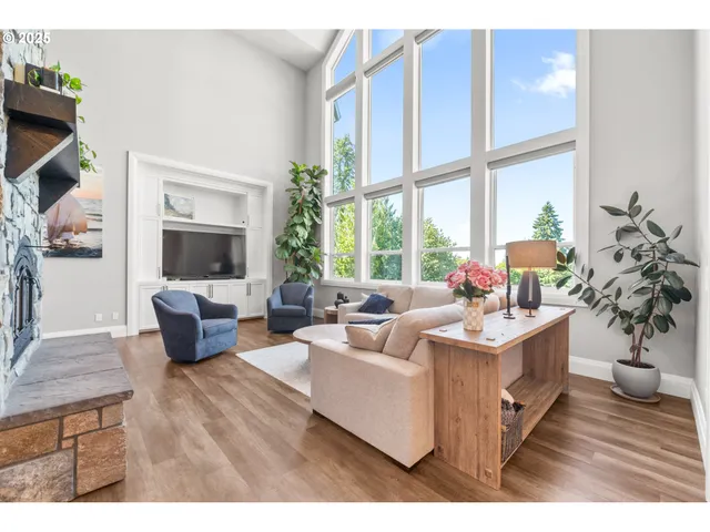 a living room with furniture a large window and a flat screen tv