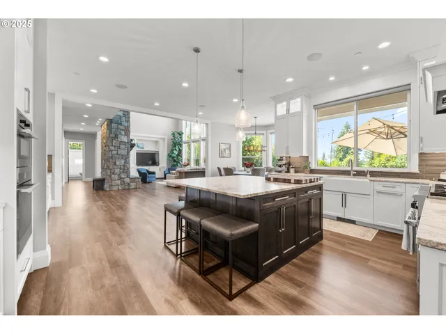 a kitchen with a table chairs refrigerator and microwave