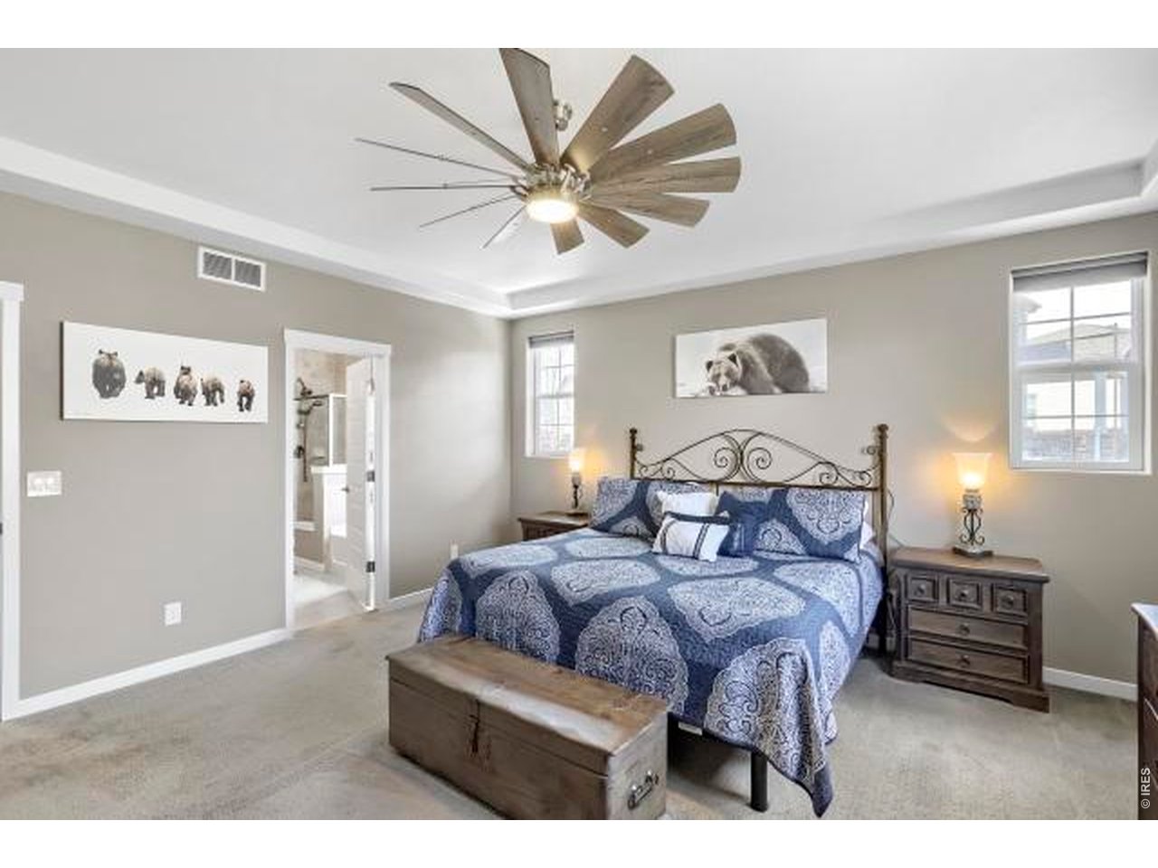 2169 Day Spring Drive Windsor, CO 80550 - Photo 12 of 39 a bedroom with a bed and a chandelier
