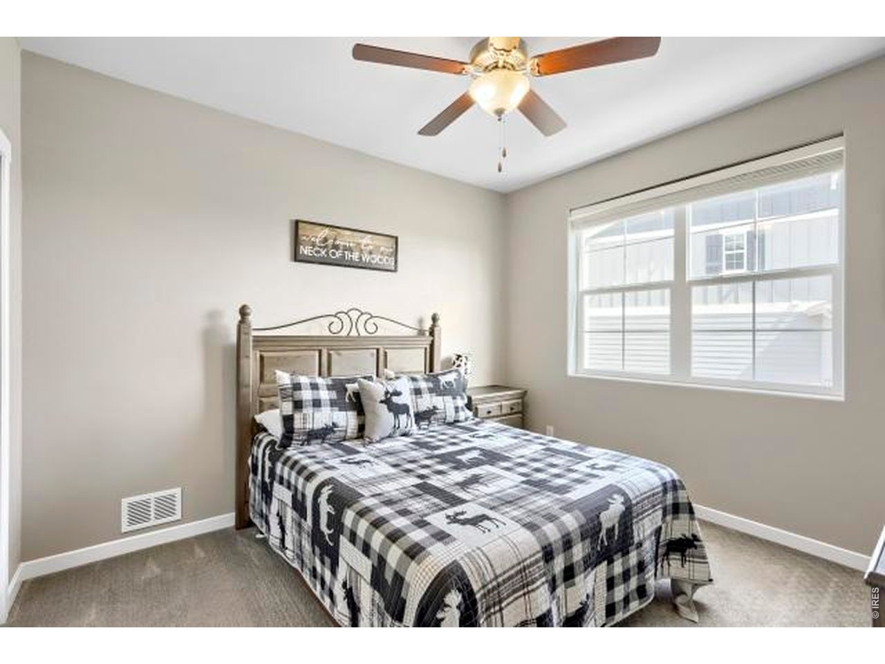 2169 Day Spring Drive Windsor, CO 80550 - Photo 16 of 39 a bedroom with a bed and a chandelier