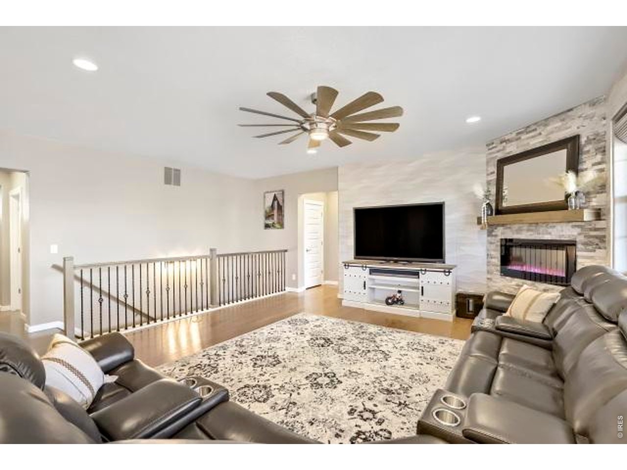 2169 Day Spring Drive Windsor, CO 80550 - Photo 5 of 39 a living room with furniture or flat screen tv and a fireplace