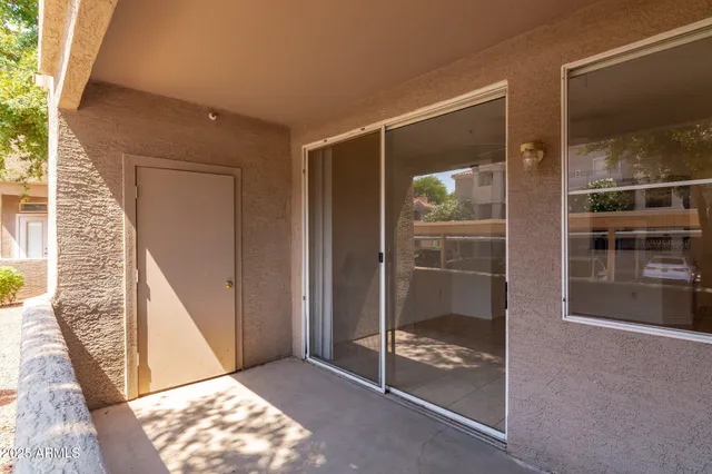 a view of an entryway with wooden floor and door