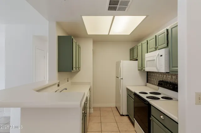a kitchen with a sink stove and refrigerator