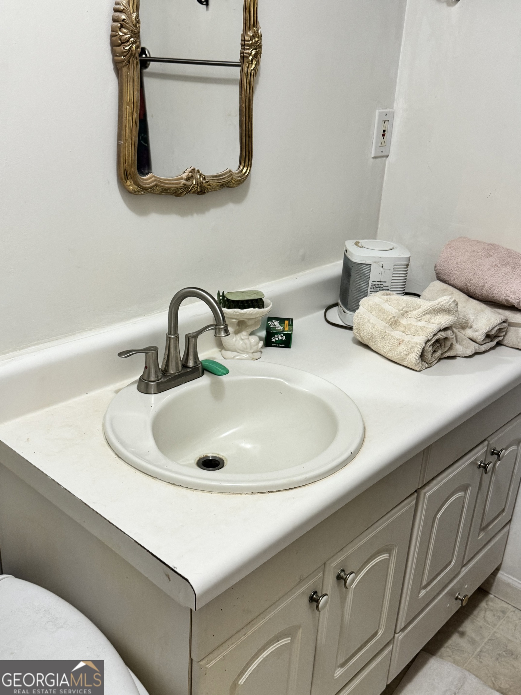 1567 Locust Grove Road Locust Grove, GA 30248 - Photo 33 of 33 a bathroom with a sink and a mirror