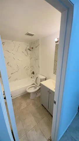 a bathroom with a sink a toilet and mirror