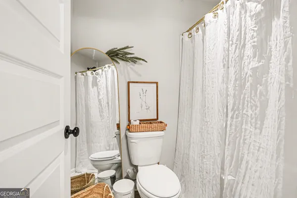 a bathroom with a granite countertop toilet a sink and a shower