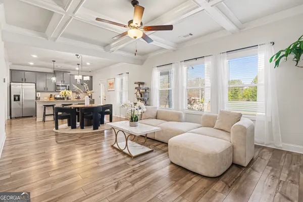 a living room with furniture and wooden floor