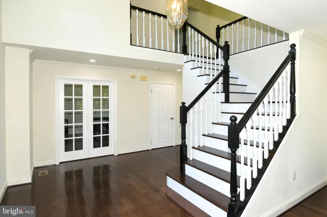 a view of entryway with wooden floor and front door