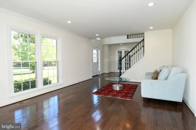 a living room with furniture and stairs