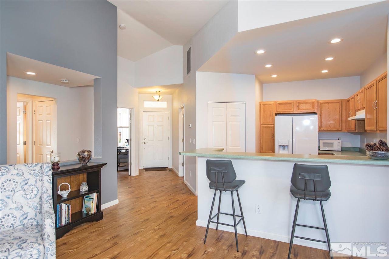 700 Caughlin Glen Reno, NV 89519 - Photo 7 of 25 a kitchen with stainless steel appliances kitchen island granite countertop a refrigerator a stove a sink dishwasher with a dining table and chairs