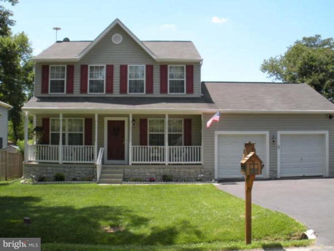 1215 Valley Road Pasadena, MD 21122 - Photo 1 of 8 a front view of a house with garden