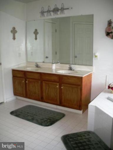 1215 Valley Road Pasadena, MD 21122 - Photo 5 of 8 a bathroom with a sink and a mirror