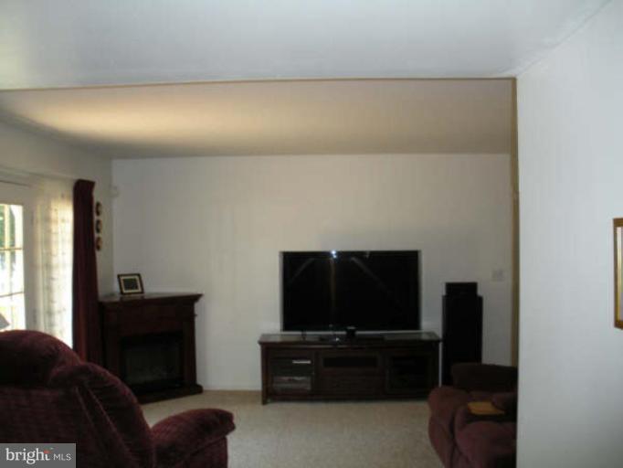 1215 Valley Road Pasadena, MD 21122 - Photo 7 of 8 a living room with furniture and a flat screen tv