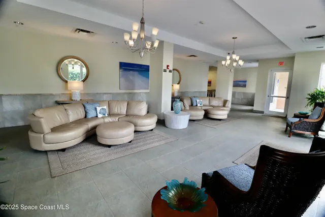 a living room with furniture and a window with wooden floor
