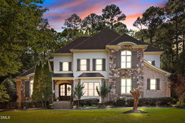 a front view of a house with swimming pool and porch