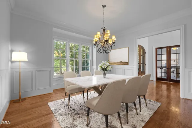 a dining room with furniture wooden floor a flat screen tv and a fireplace