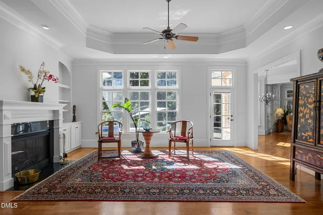 a kitchen with kitchen island granite countertop stainless steel appliances a stove cabinets and wooden floor