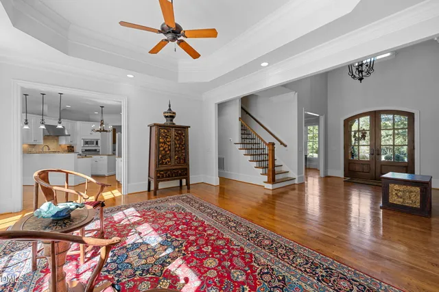 a living room with furniture and floor to ceiling windows