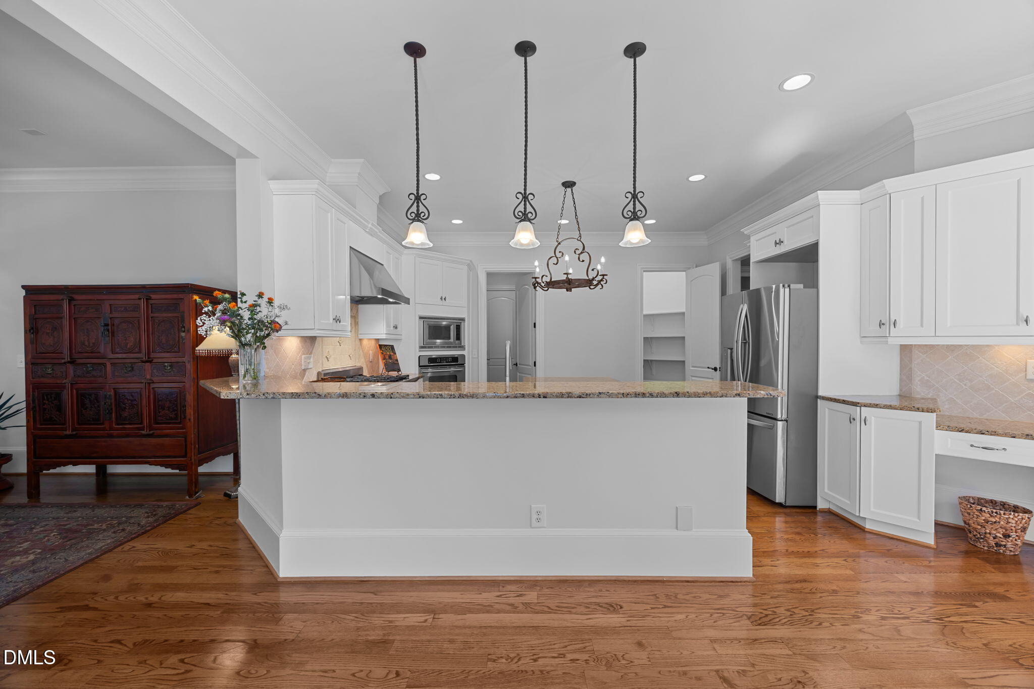 10101 Lobley Hill Lane Raleigh, NC 27613 - Photo 58 of 89 a view of a kitchen with kitchen island a counter top space stainless steel appliances and wooden floor