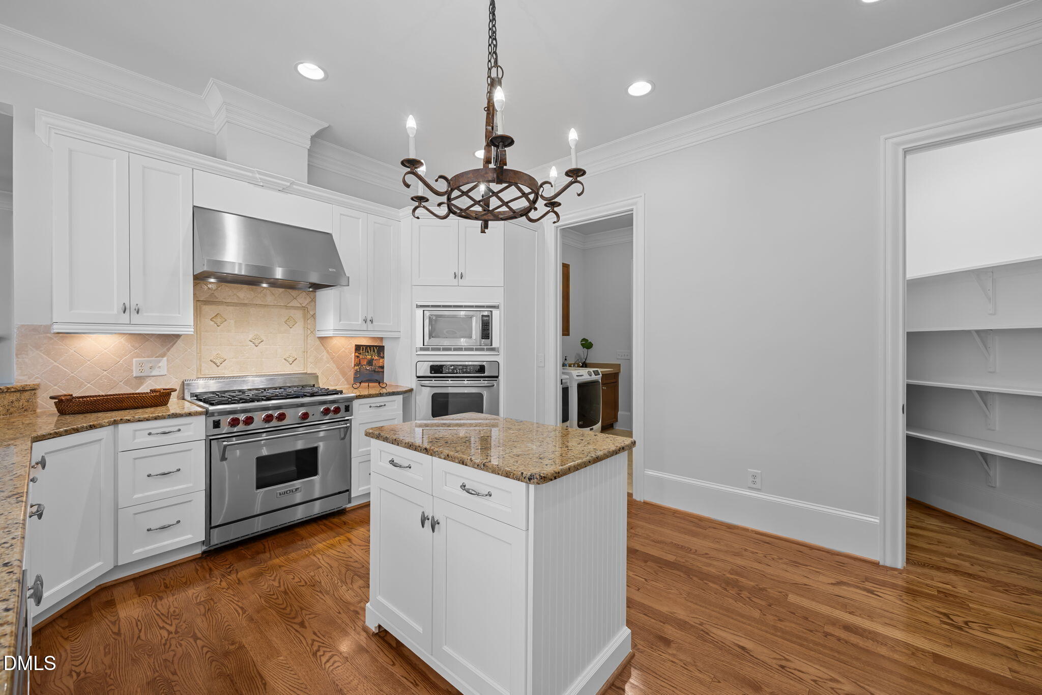 10101 Lobley Hill Lane Raleigh, NC 27613 - Photo 65 of 89 a kitchen with kitchen island granite countertop stainless steel appliances a stove cabinets and wooden floor