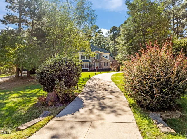 a bedroom with a bed flat screen tv and a window