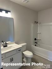 6209 Busch Way Midland, NC 28107 - Photo 7 of 17 a bathroom with a sink a toilet and shower