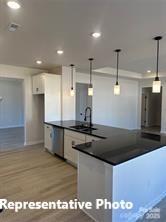 6209 Busch Way Midland, NC 28107 - Photo 9 of 17 a kitchen with stainless steel appliances granite countertop a sink a stove and a refrigerator