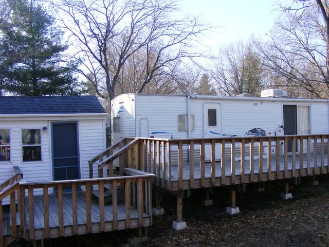 5 156th Sublette, IL 61367 - Photo 19 of 19 a view of a roof deck with wooden fence and large trees