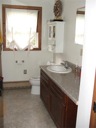 148 Adams Road Oakham, MA 01068 - Photo 12 of 14 a bathroom with a sink a toilet and a window
