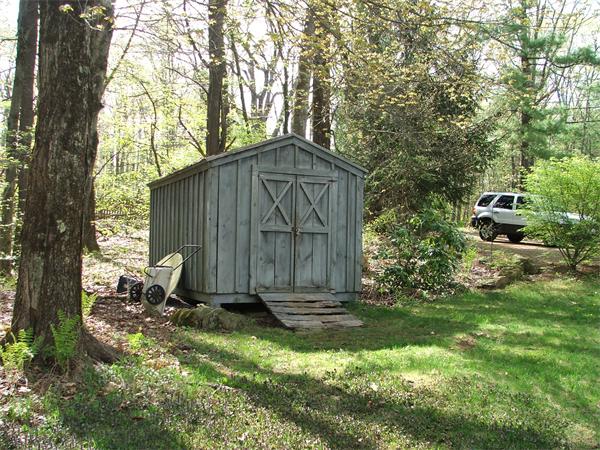 148 Adams Road Oakham, MA 01068 - Photo 3 of 14 a backyard of a house with large trees and wooden fence