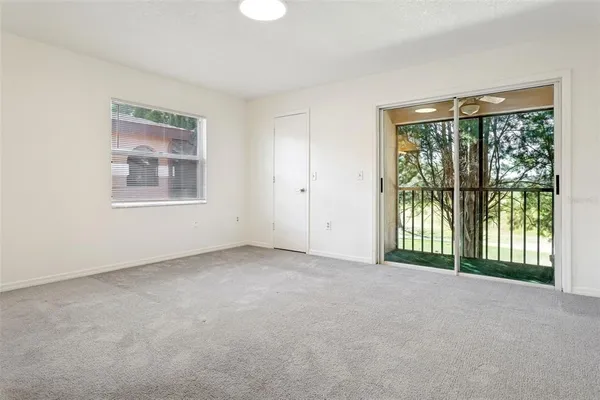 an empty room with windows and closet