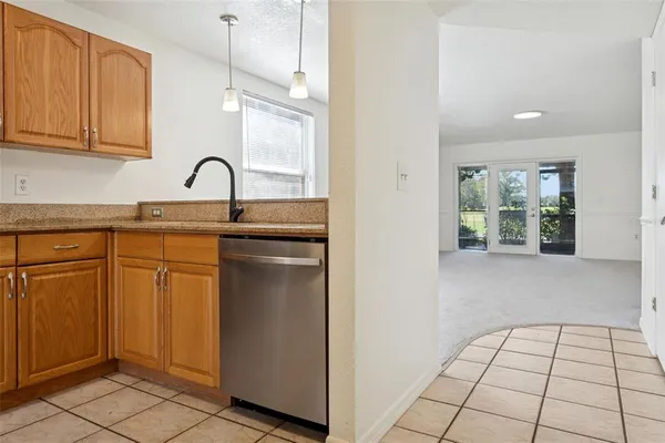 a kitchen with stainless steel appliances a sink stove and cabinets
