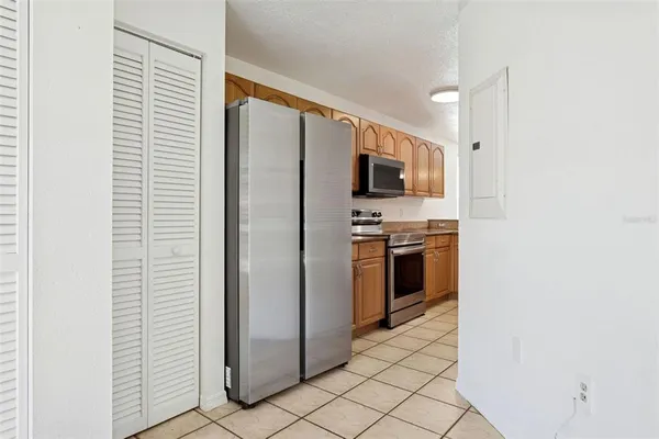 a kitchen with stainless steel appliances a refrigerator and a stove top oven