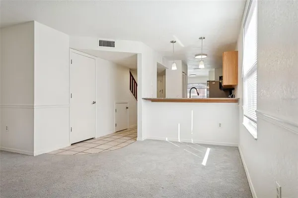 an empty room with an empty space and window