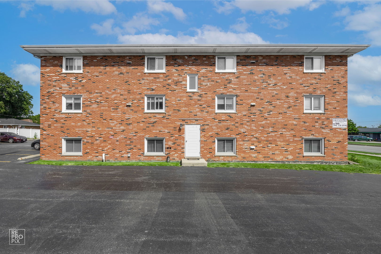 6315 Joliet Road, Unit 6 Countryside, IL 60525 - Photo 1 of 10 a front view of a building with a yard and garage