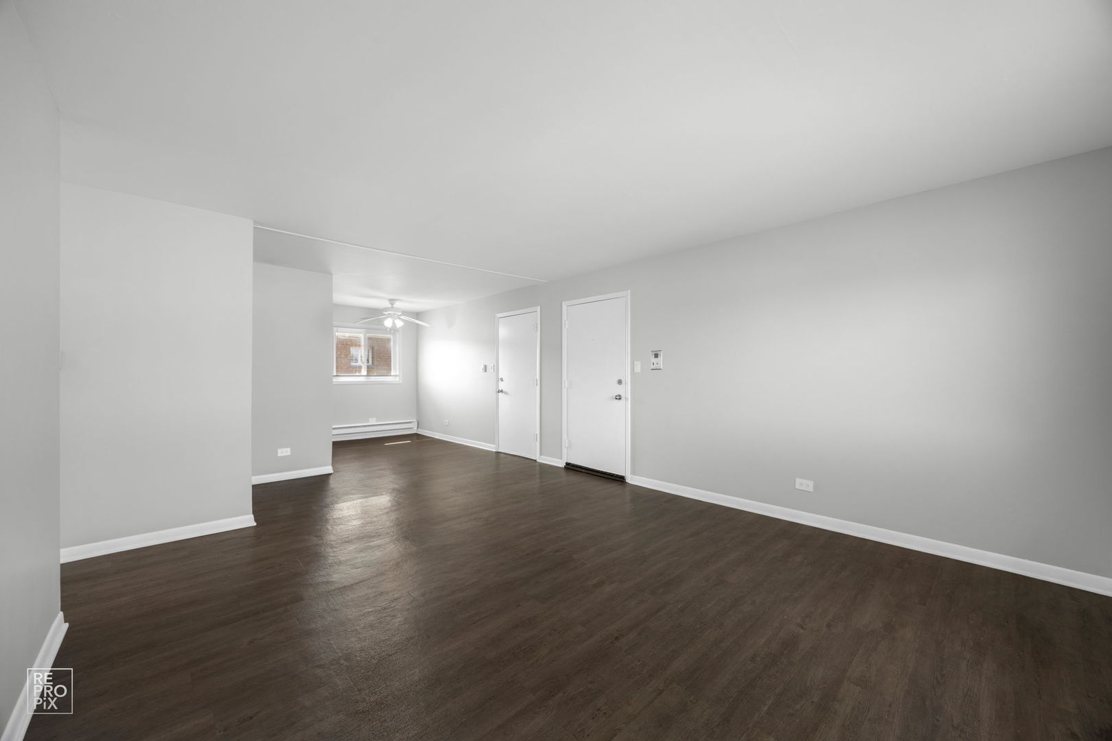 6315 Joliet Road, Unit 6 Countryside, IL 60525 - Photo 4 of 10 a view of an empty room with wooden floor and windows