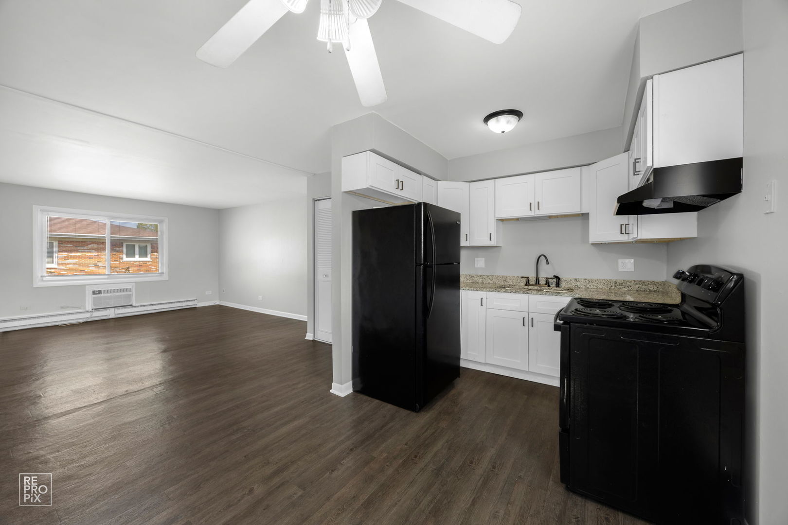 6315 Joliet Road, Unit 6 Countryside, IL 60525 - Photo 5 of 10 a kitchen with a refrigerator and a stove top oven