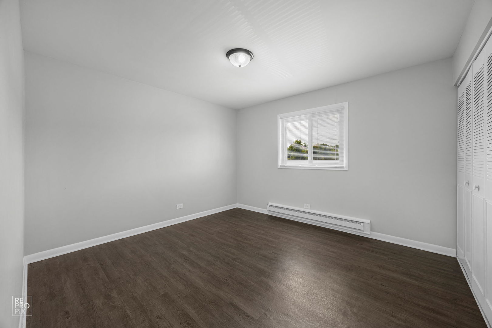 6315 Joliet Road, Unit 6 Countryside, IL 60525 - Photo 10 of 10 an empty room with wooden floor and windows