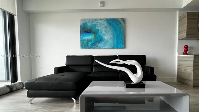 a living room with a couch and a potted plant